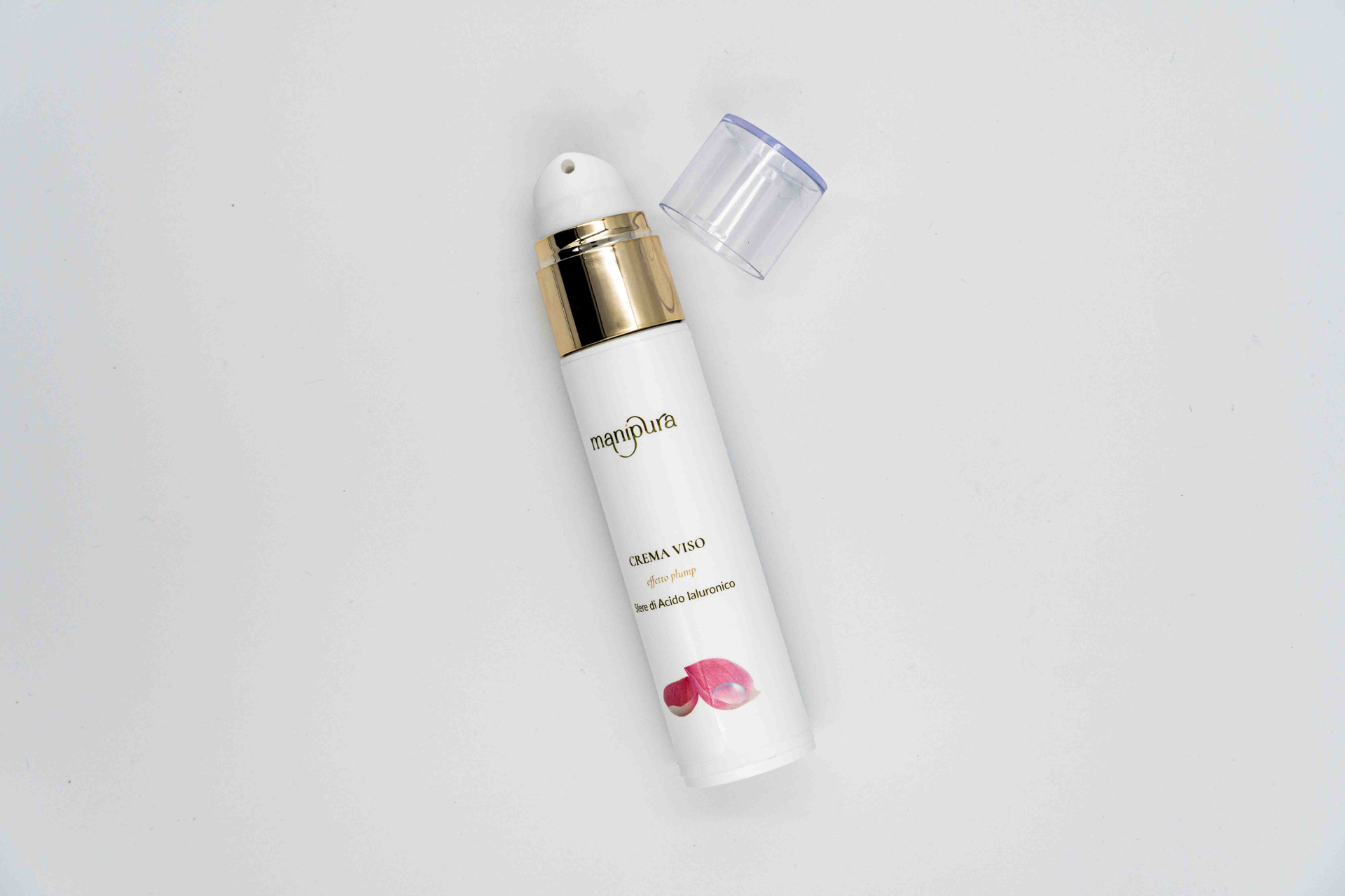 Flacone di crema viso Manipura effetto plump senza tappo, ripreso dall’alto su sfondo bianco.