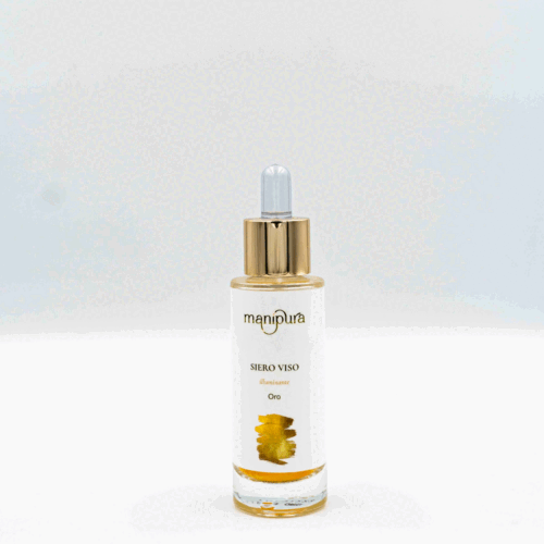 Boccetta aperta del siero viso illuminante Oro di Manipura con contagocce dorato appoggiato su sfondo bianco.