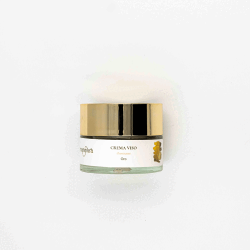 Vasetto di Crema Viso Illuminante Oro Manipura con tappo dorato, fotografato dall’alto su sfondo bianco.